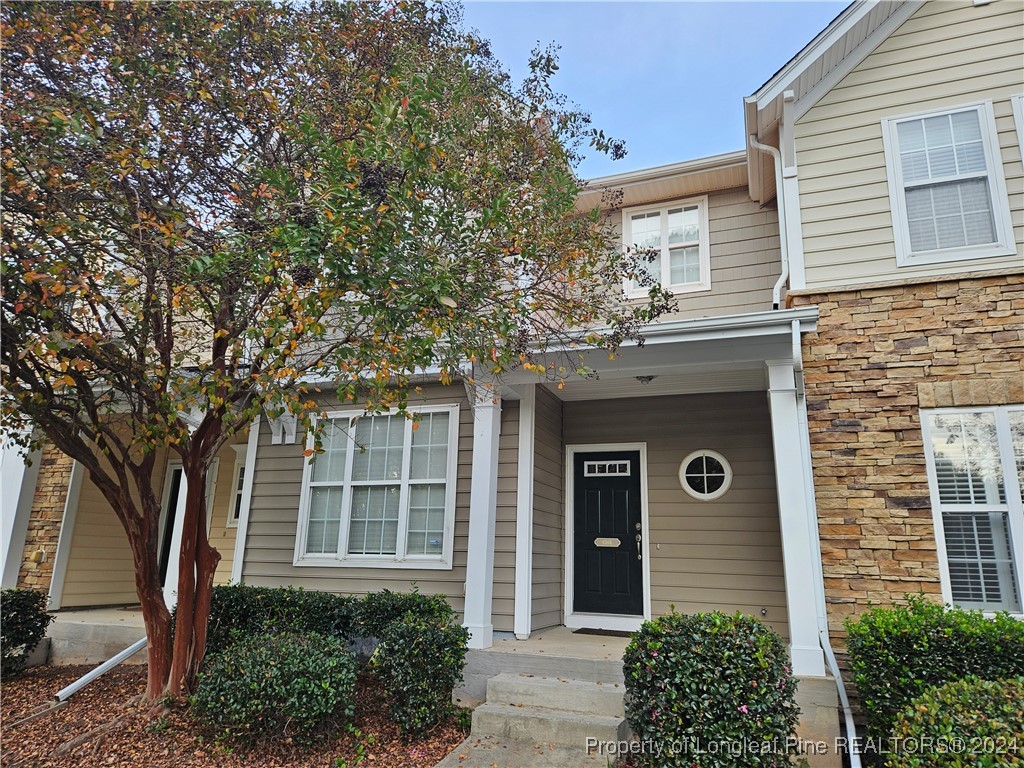 front view of a house with a tree