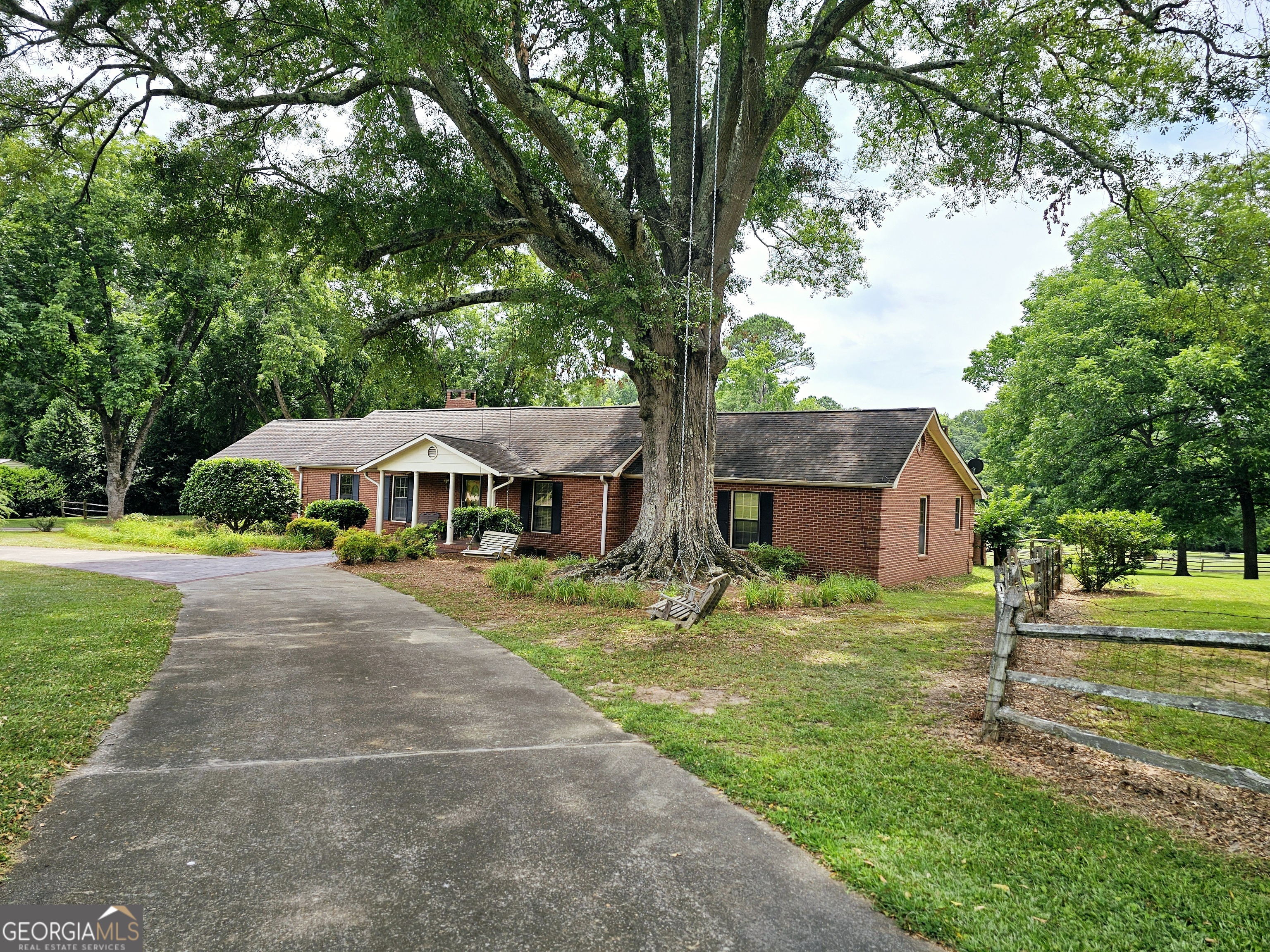 a yellow house with trees in front of it