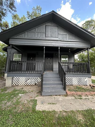 a front view of a house with a bench