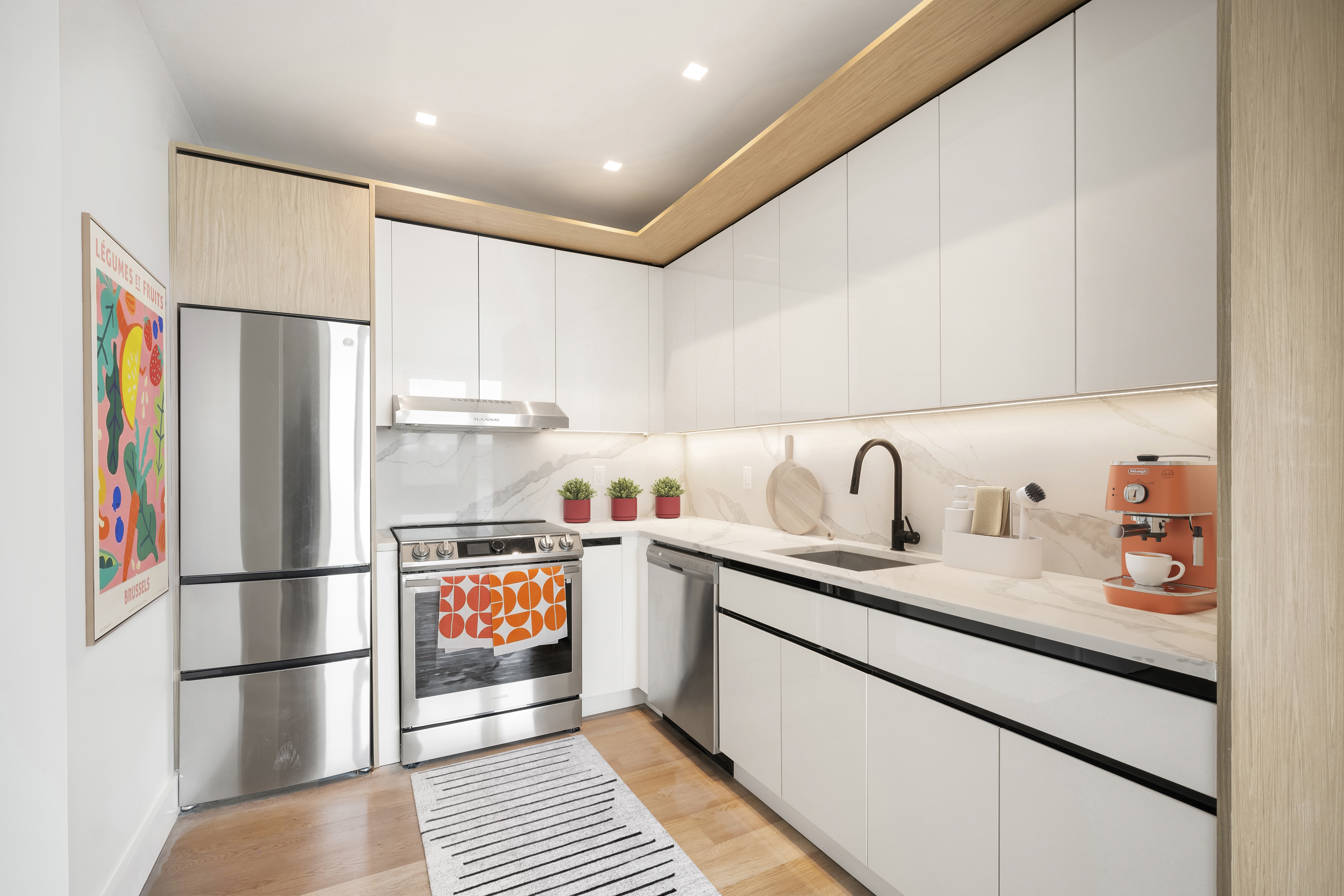 a kitchen with stainless steel appliances a refrigerator sink and cabinets