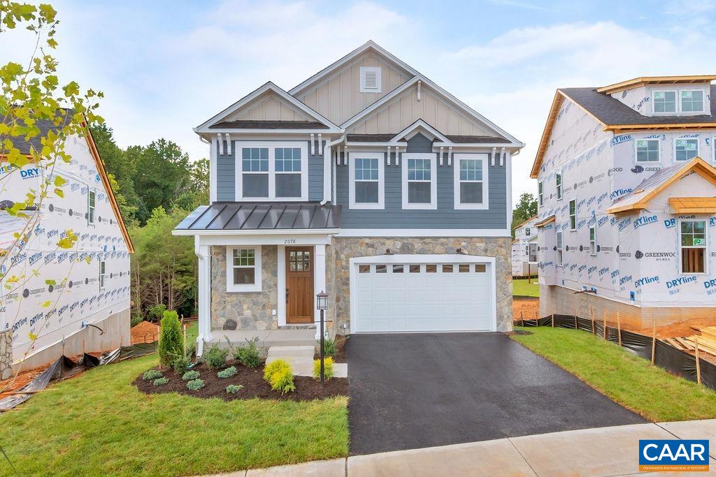 a front view of a house with a garden and garage