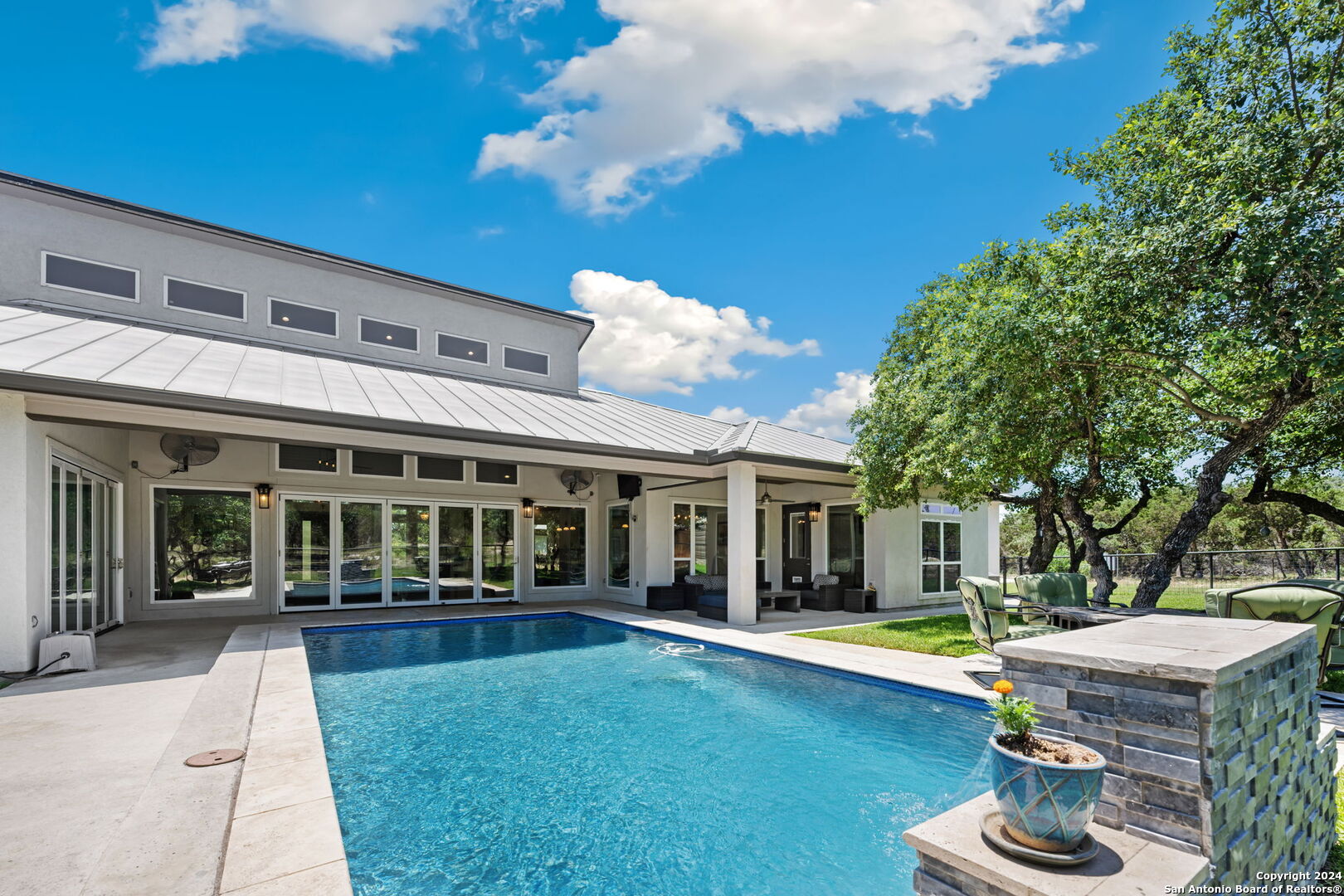 a view of a house with swimming pool and porch with furniture