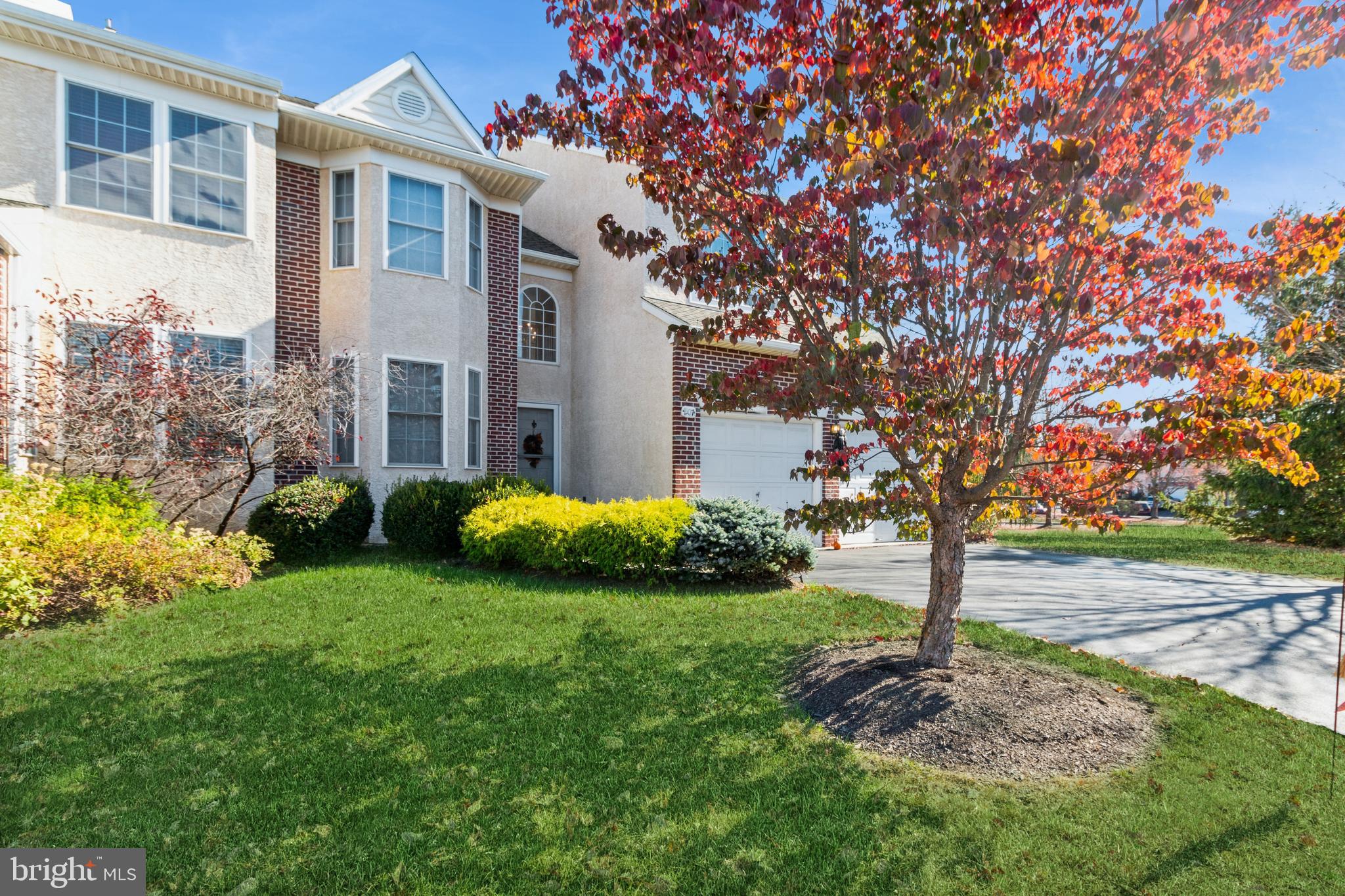 a view of a house with a yard and tree s