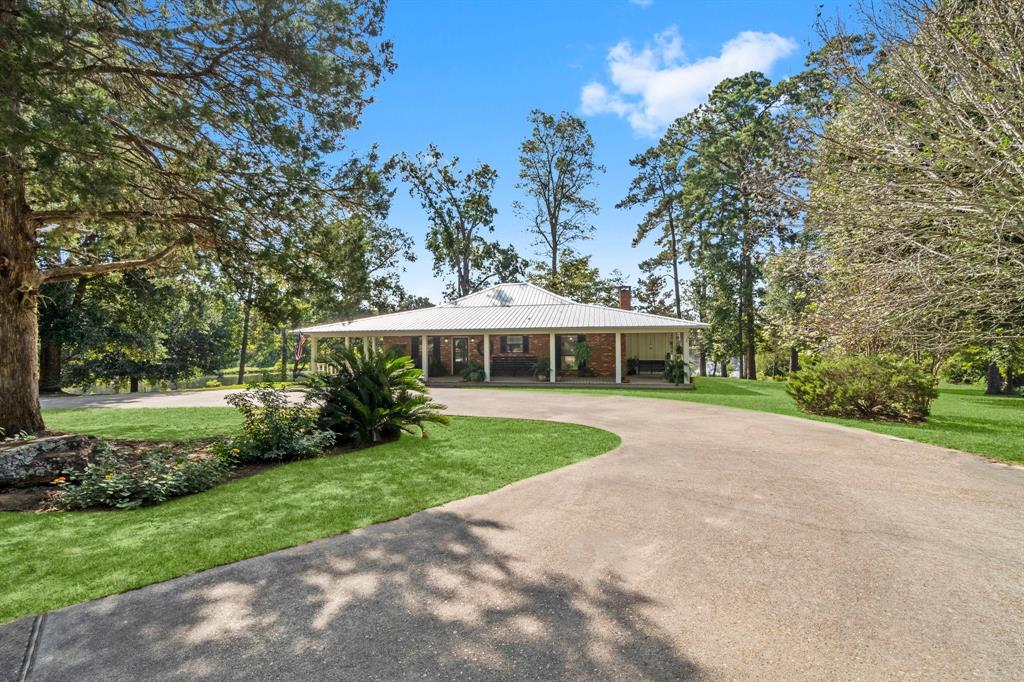 a view of a house with yard and tree s