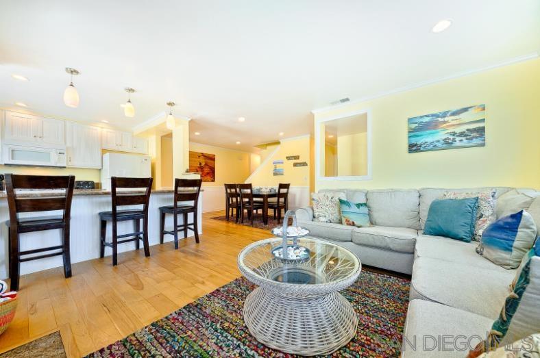 a living room with furniture and kitchen view