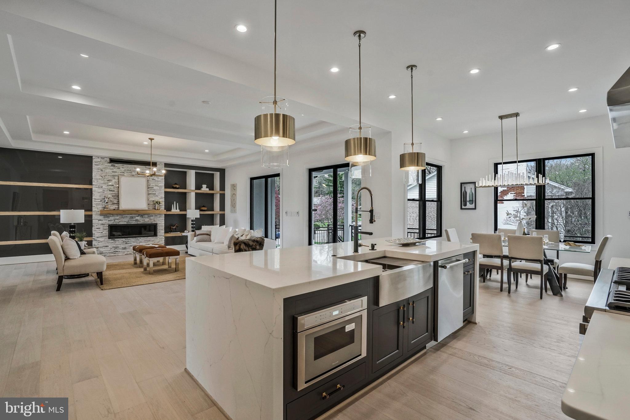 a open kitchen with stainless steel appliances granite countertop a stove and chairs