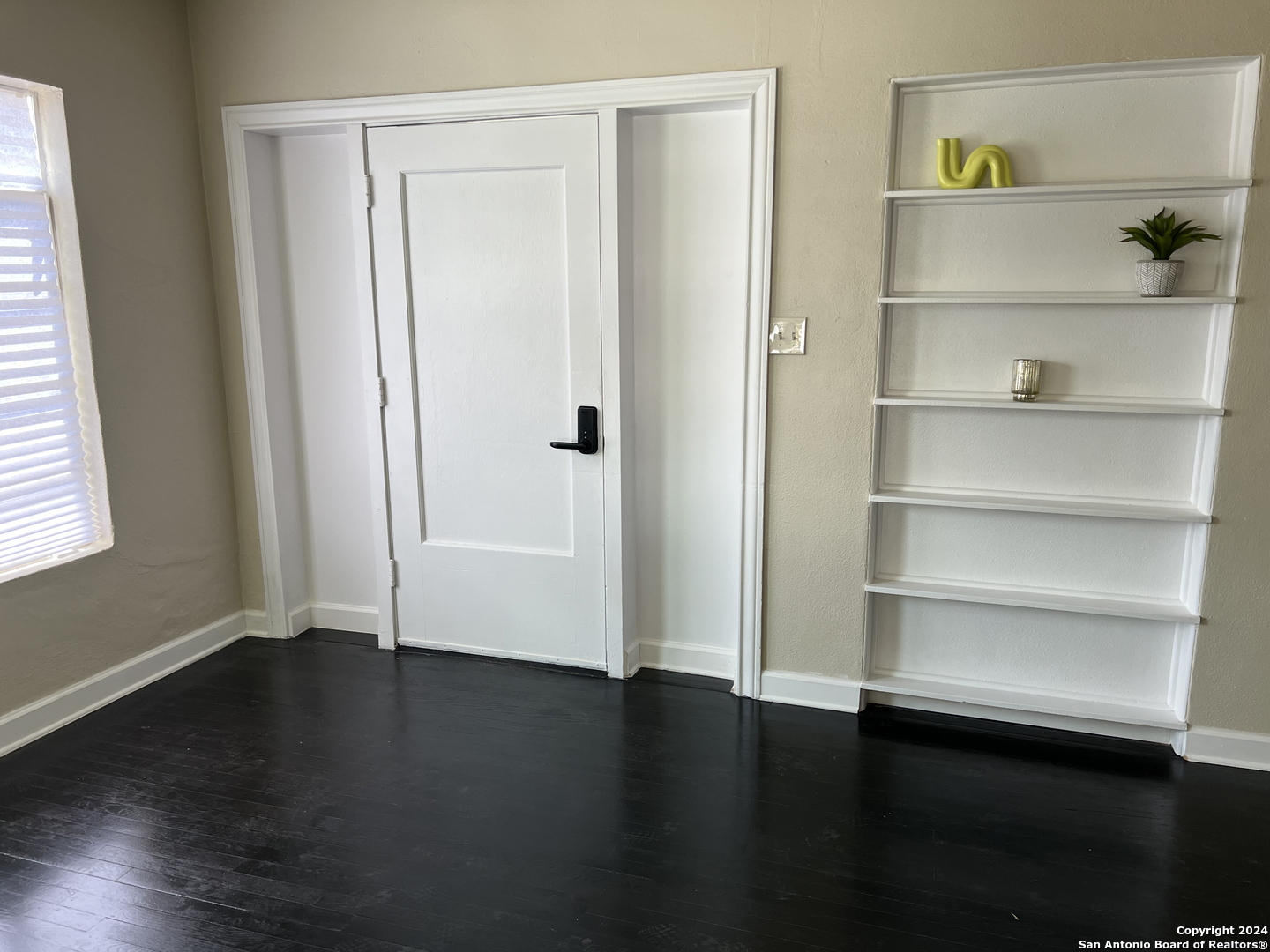 a view of a room with wooden floor