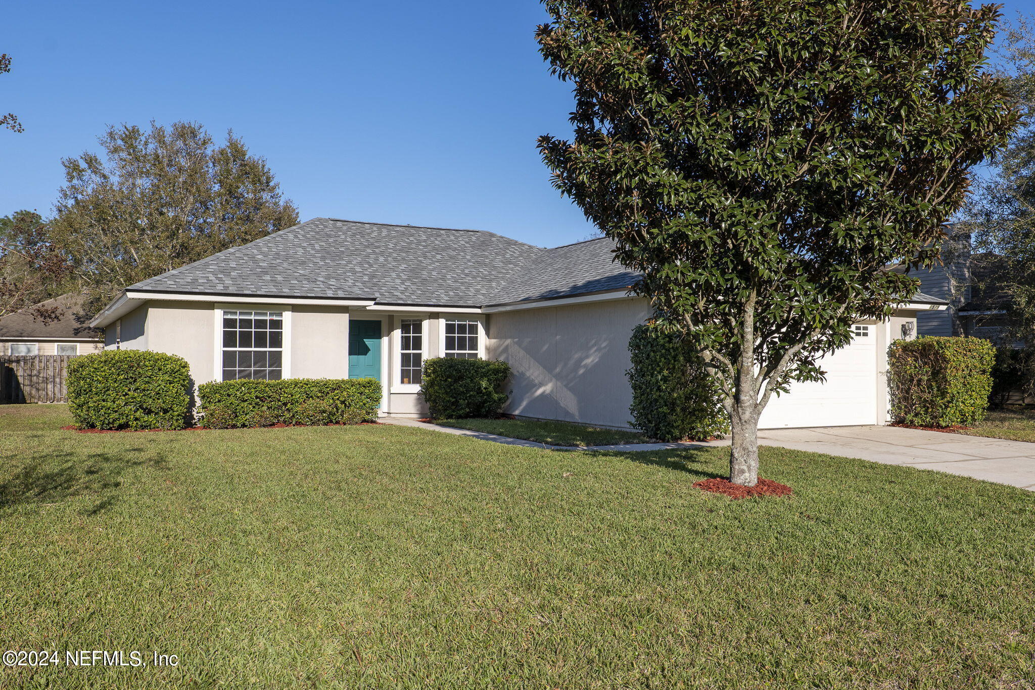 a front view of house with yard and trees