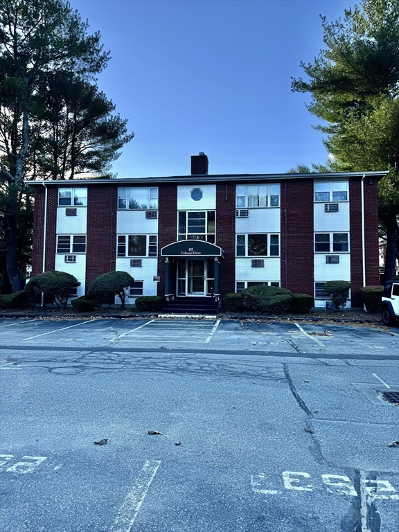 a front view of a building and trees