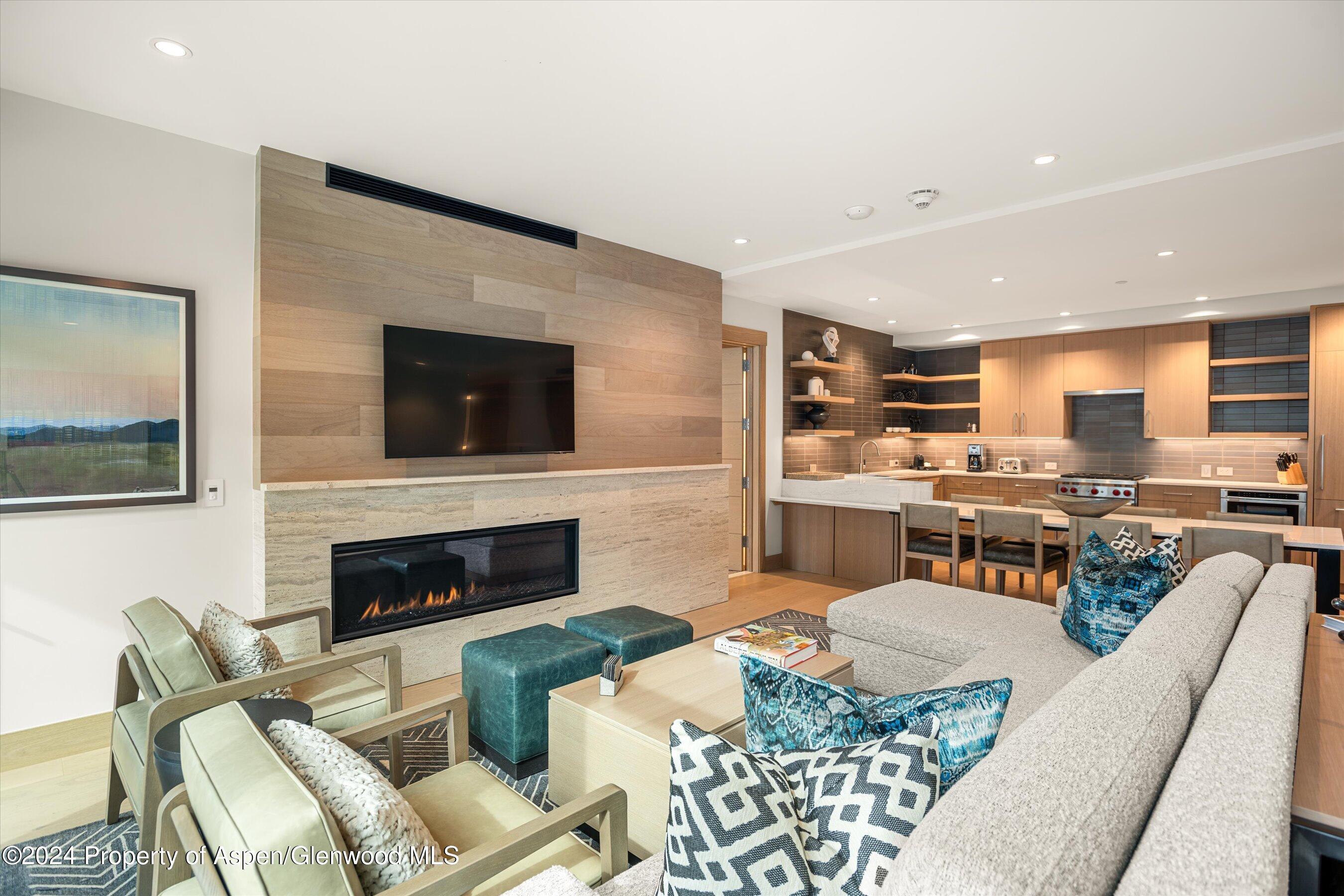 a living room with furniture fireplace and flat screen tv