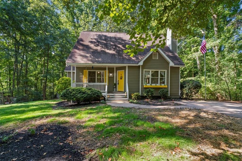 a view of a house with backyard porch and sitting area