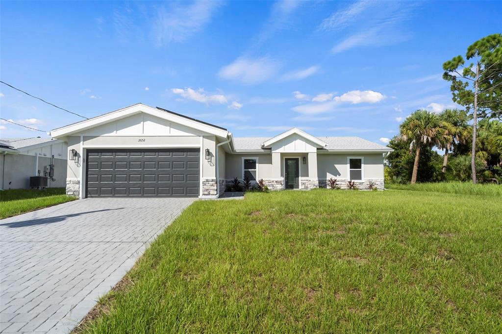 a front view of a house with a yard and garage