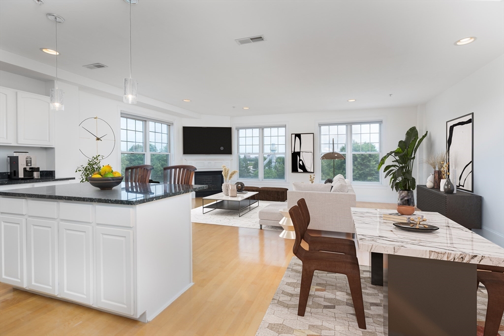 a kitchen with stainless steel appliances kitchen island granite countertop a sink and cabinets