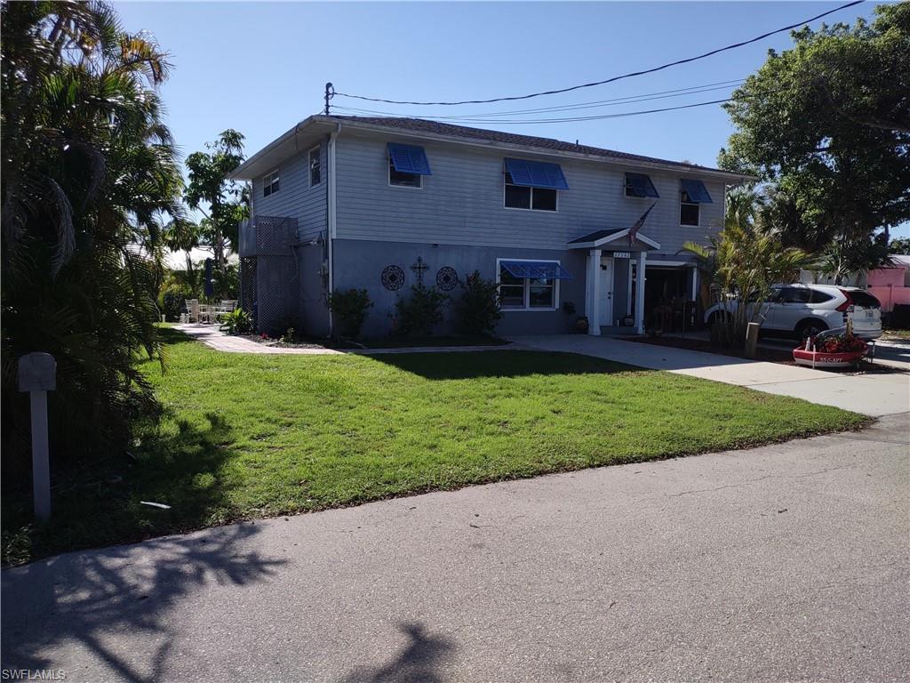 a front view of house with yard and green space