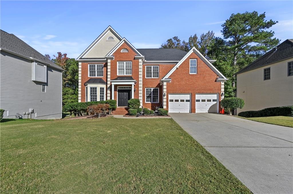 a front view of a house with a yard and garage