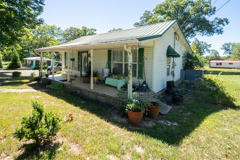 a view of a house with swimming pool and garden