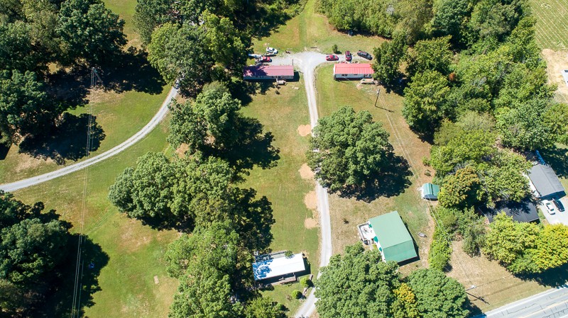 an aerial view of a house with a yard and lake view