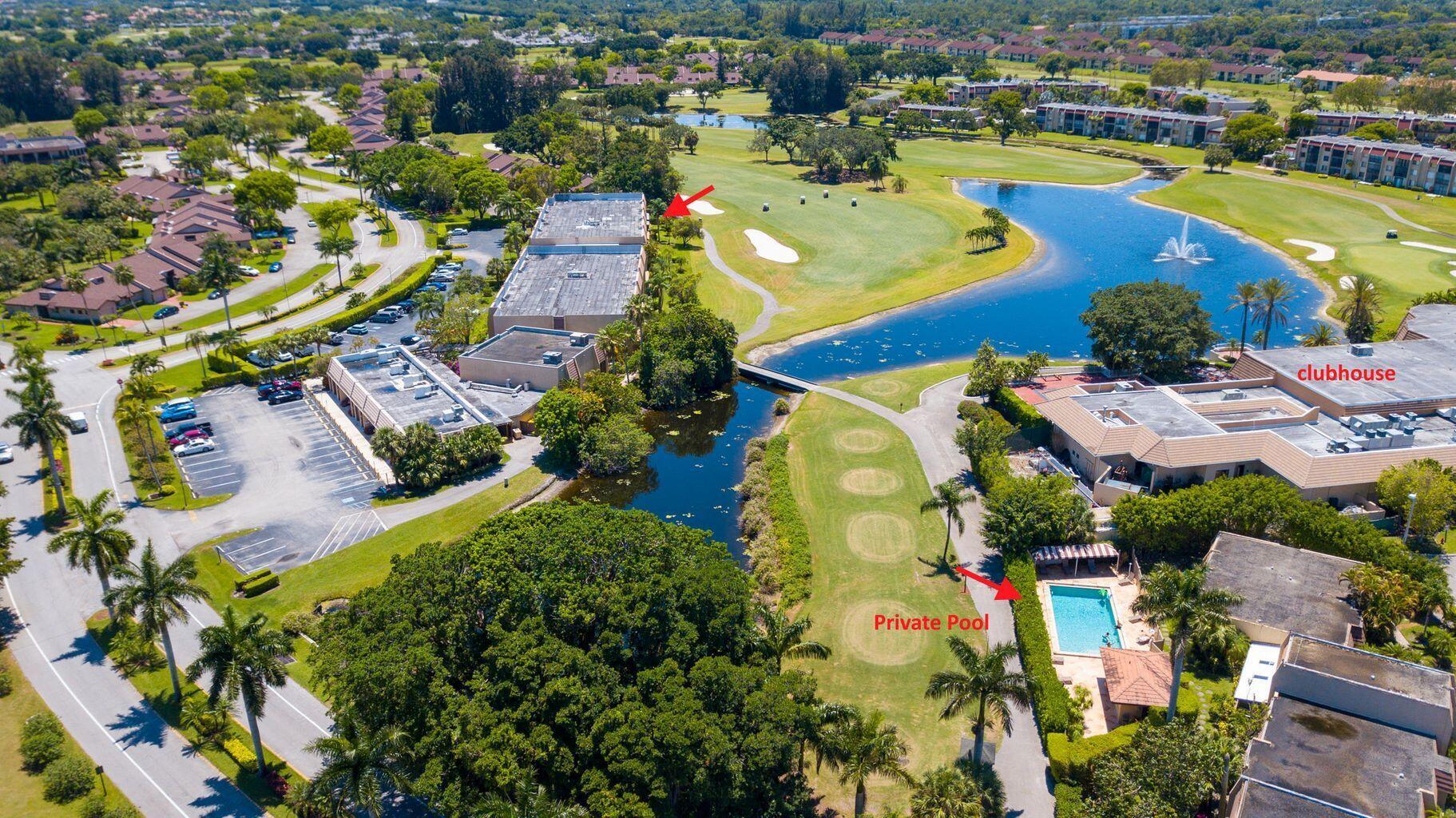 an aerial view of residential houses with outdoor space and swimming pool