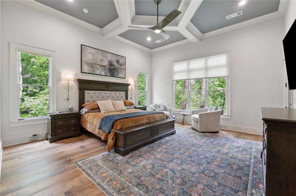 a bed sitting in a spacious bedroom next to a window