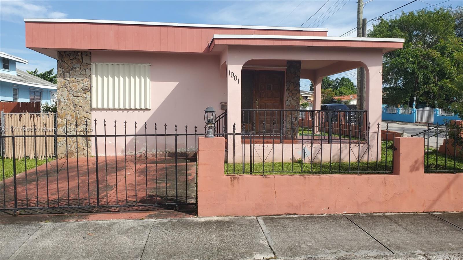 a view of a house with a small yard and wooden floor and fence