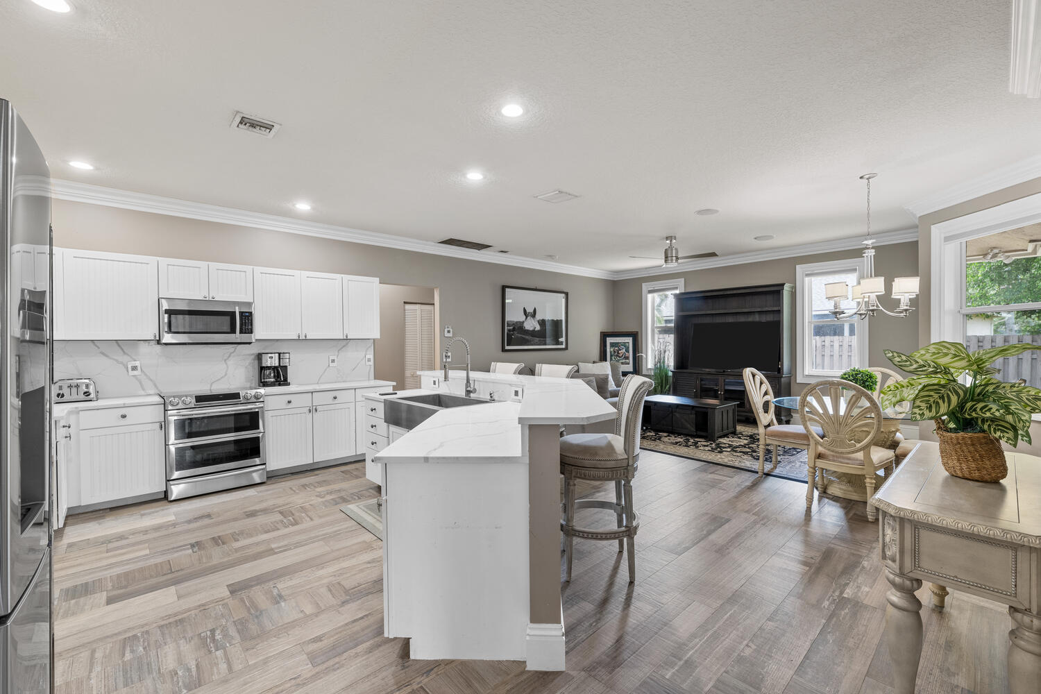 a large white kitchen with stainless steel appliances