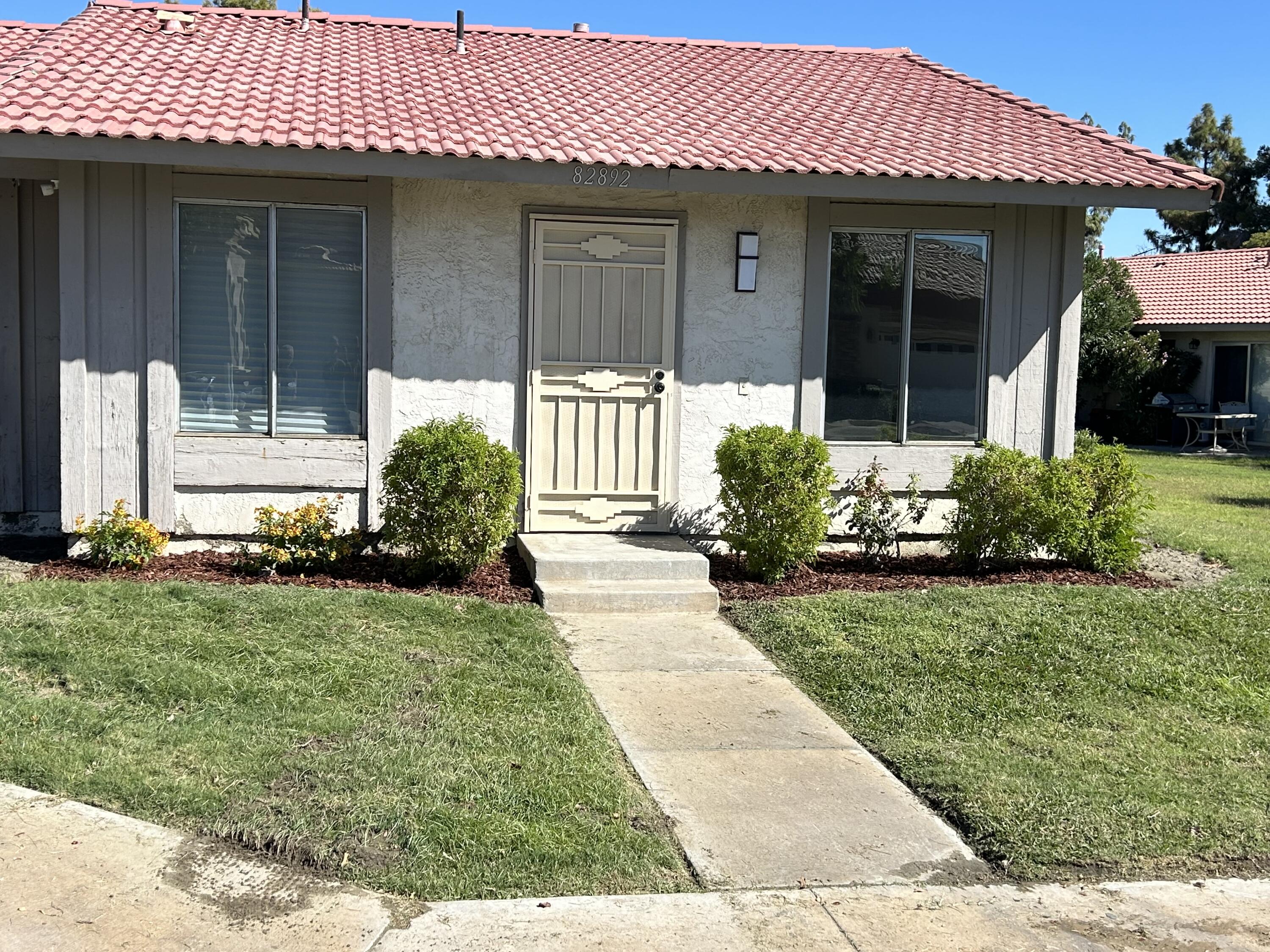 a front view of a house with garden