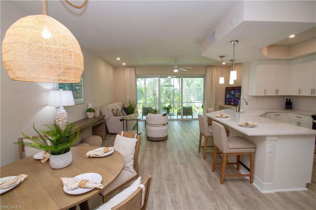 a living room with kitchen island furniture and a potted plant