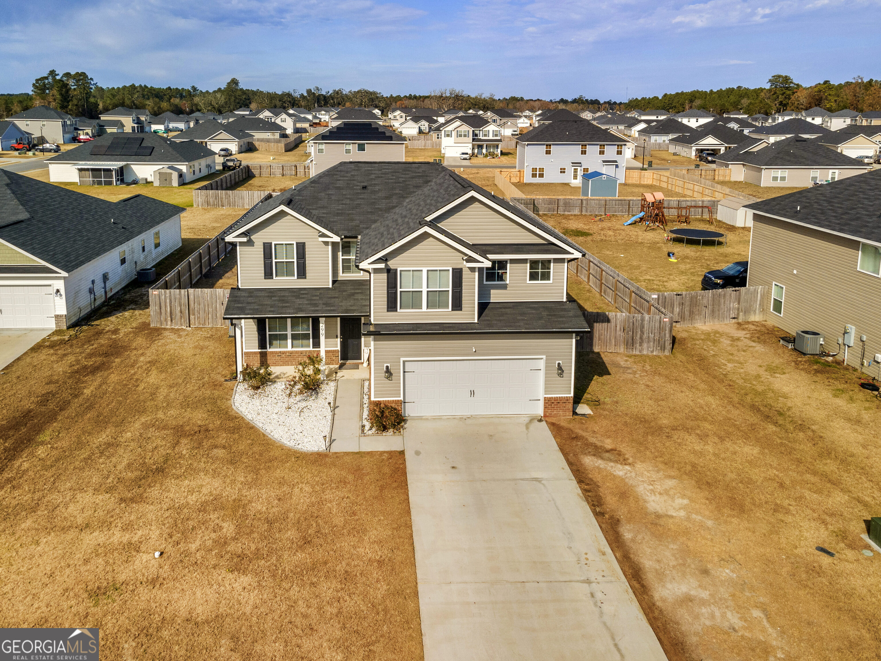 an aerial view of a house with a yard