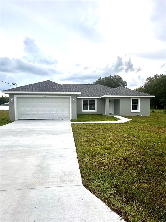 a front view of house with yard and lake view