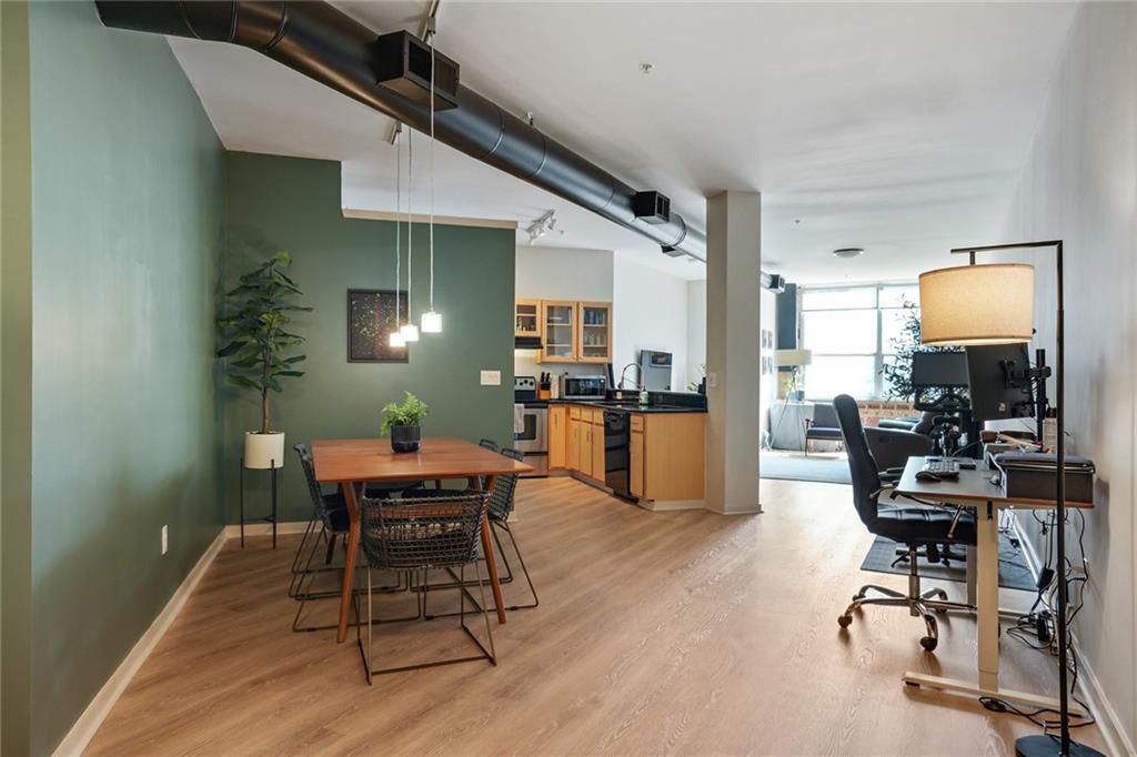 a view of a dining room with furniture and wooden floor