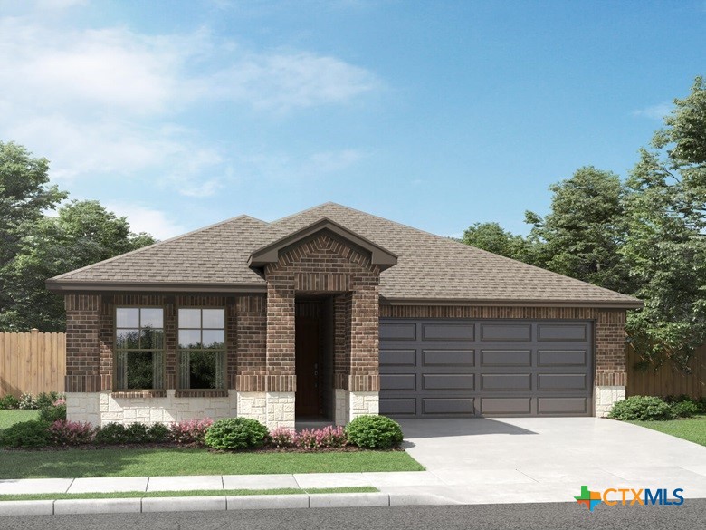 a front view of a house with a garden and garage