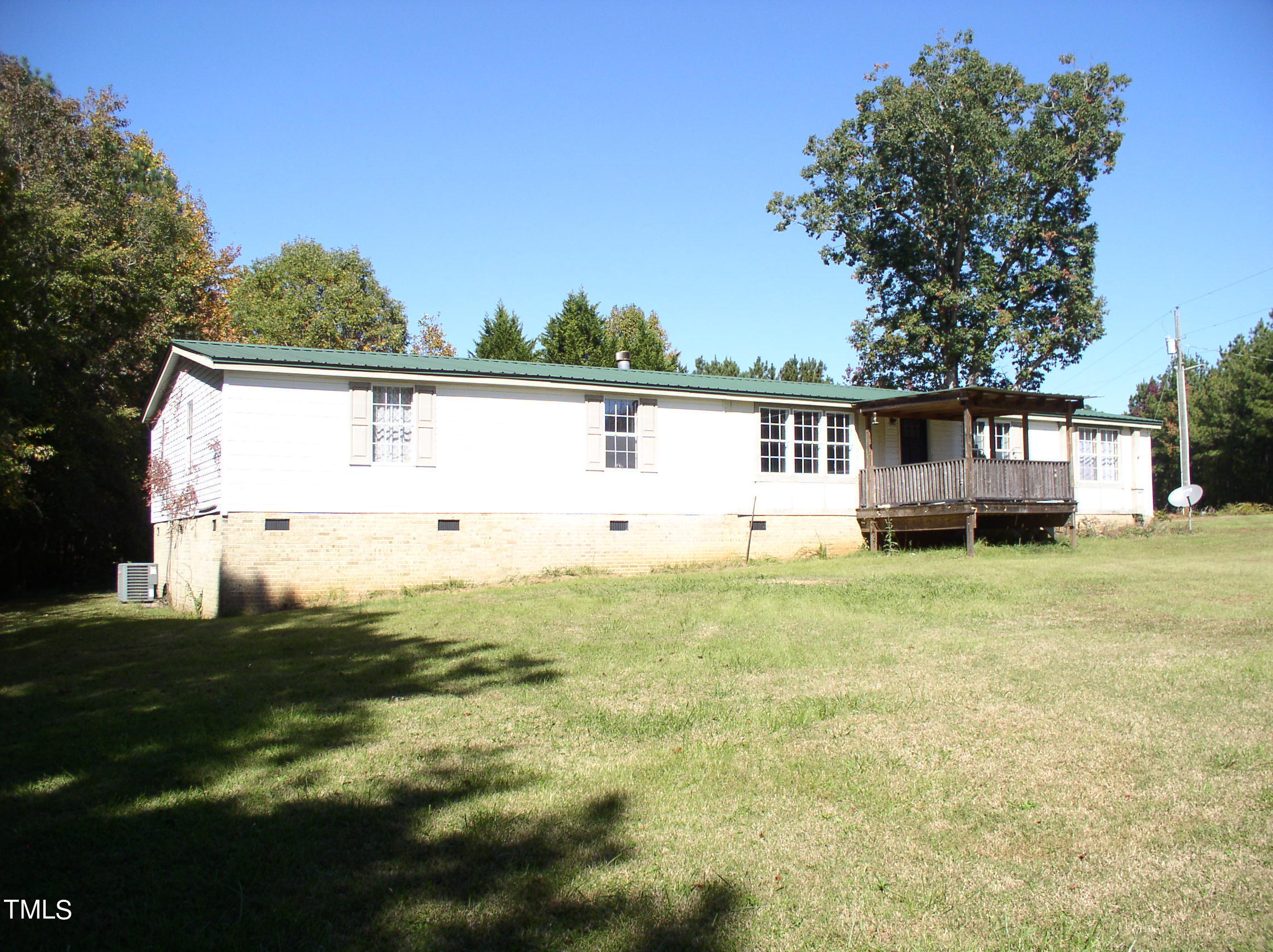 a view of house with backyard and garden