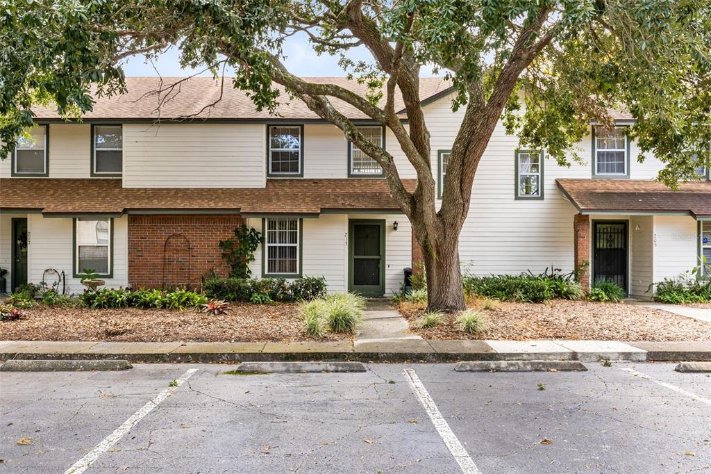 front view of a brick house with a yard