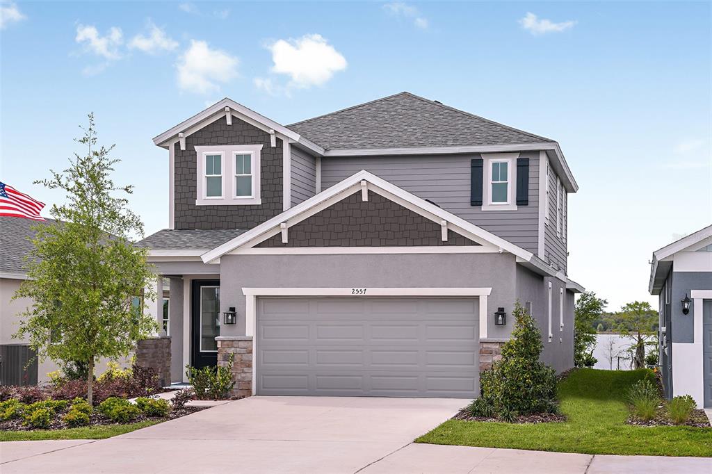 a front view of a house with a yard and garage