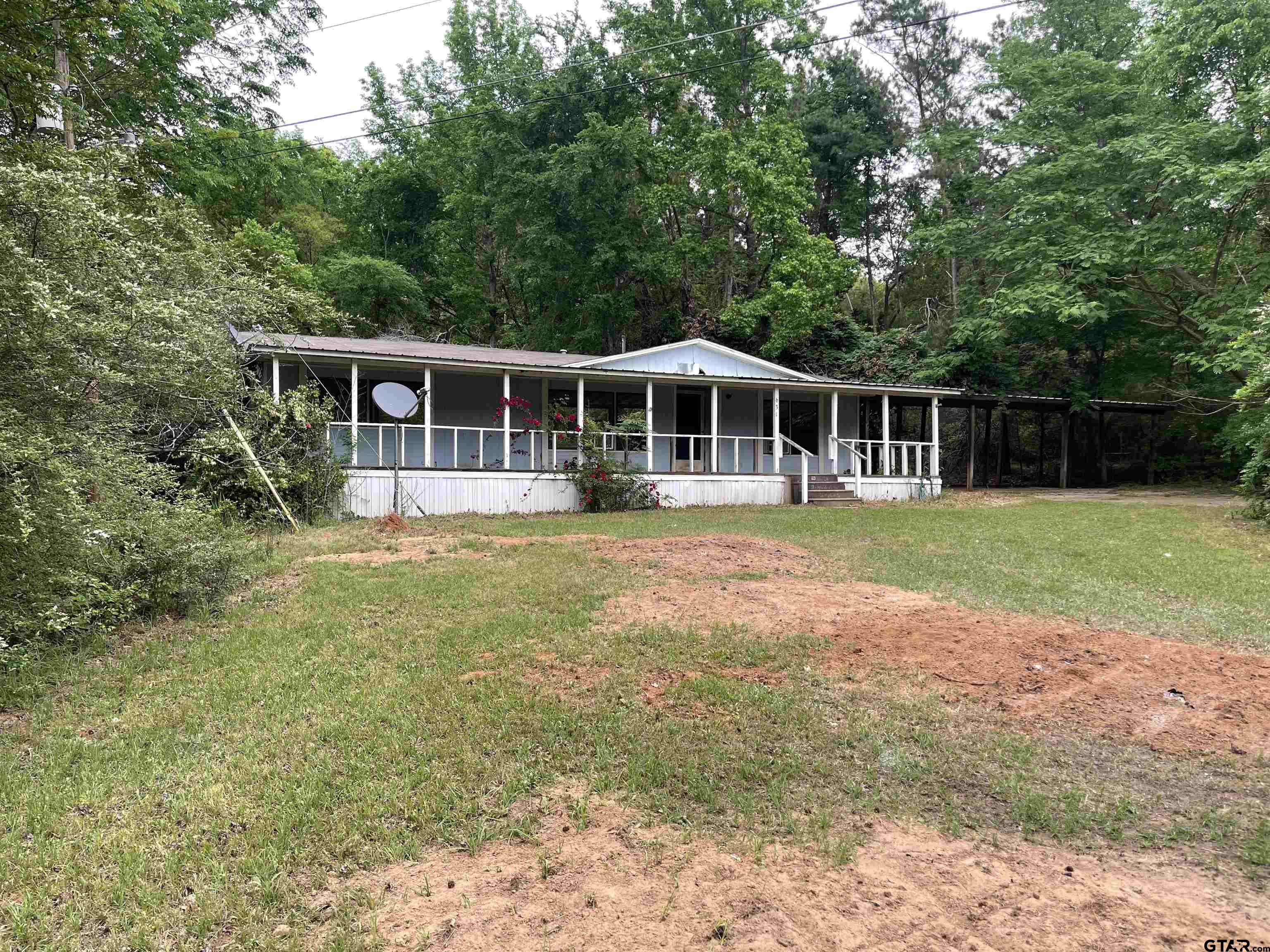 a view of a house with a yard and sitting area