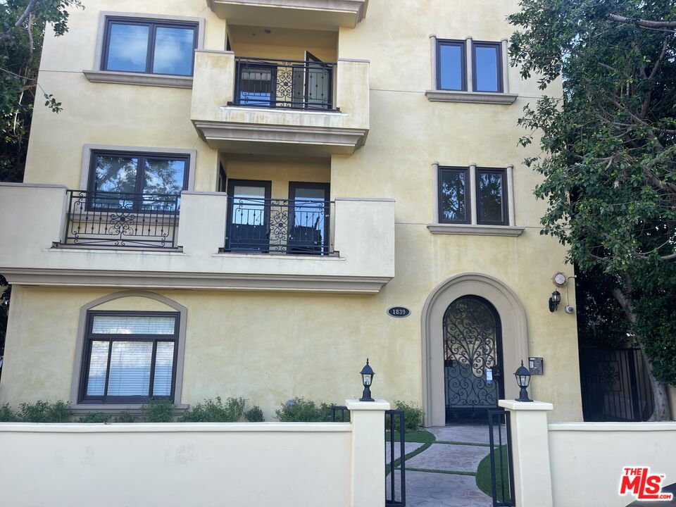 a front view of a house with plants