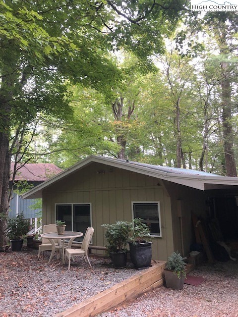 a backyard of a house with table and chairs