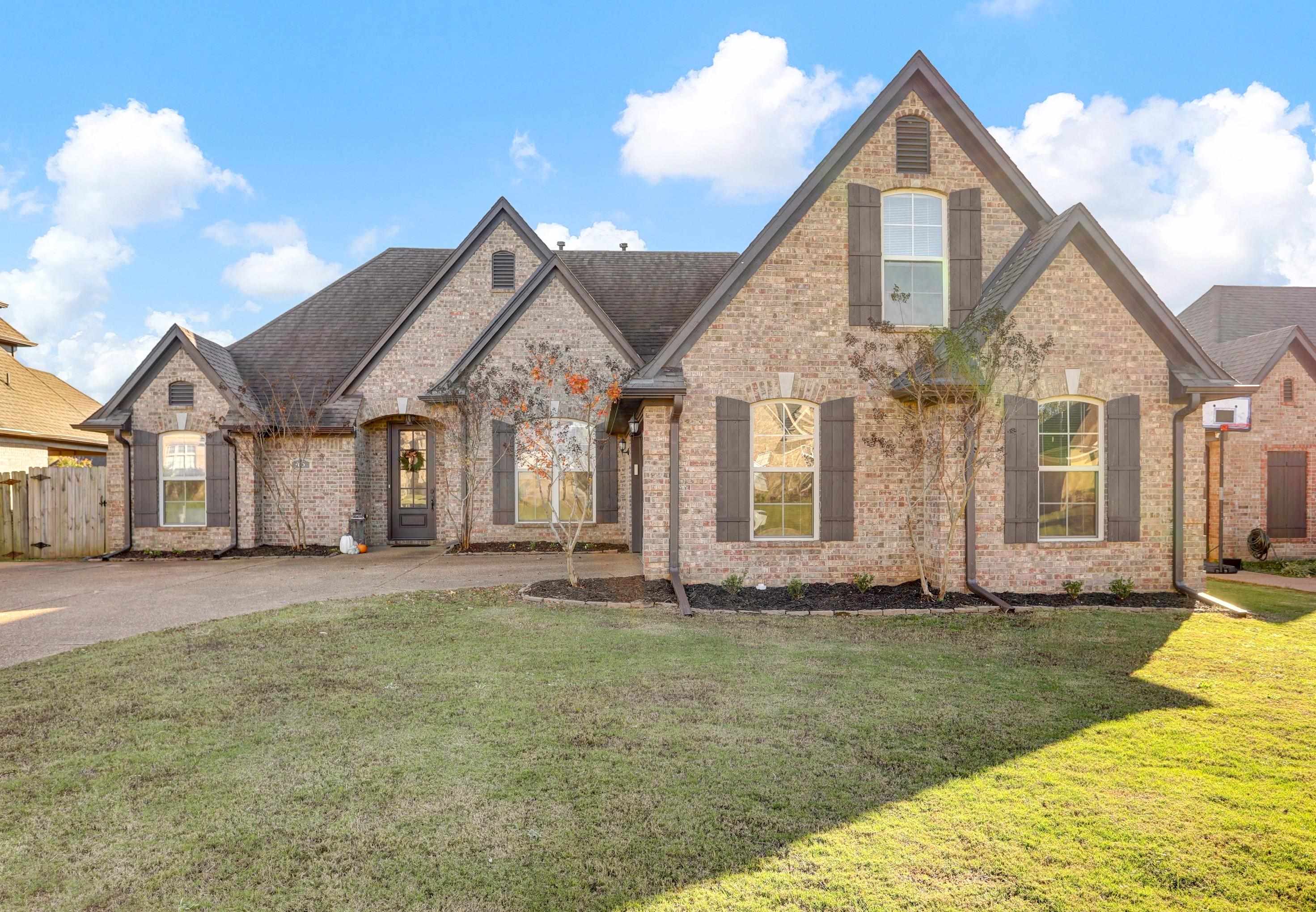 a front view of a house with a yard