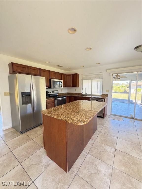 a large kitchen with kitchen island granite countertop a large counter top and appliances