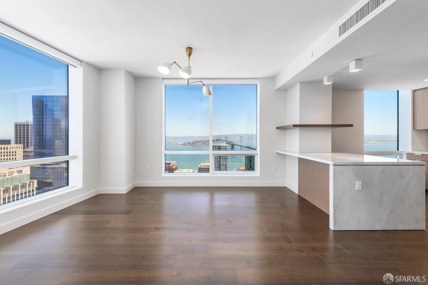 a view of wooden floor and windows in an empty room