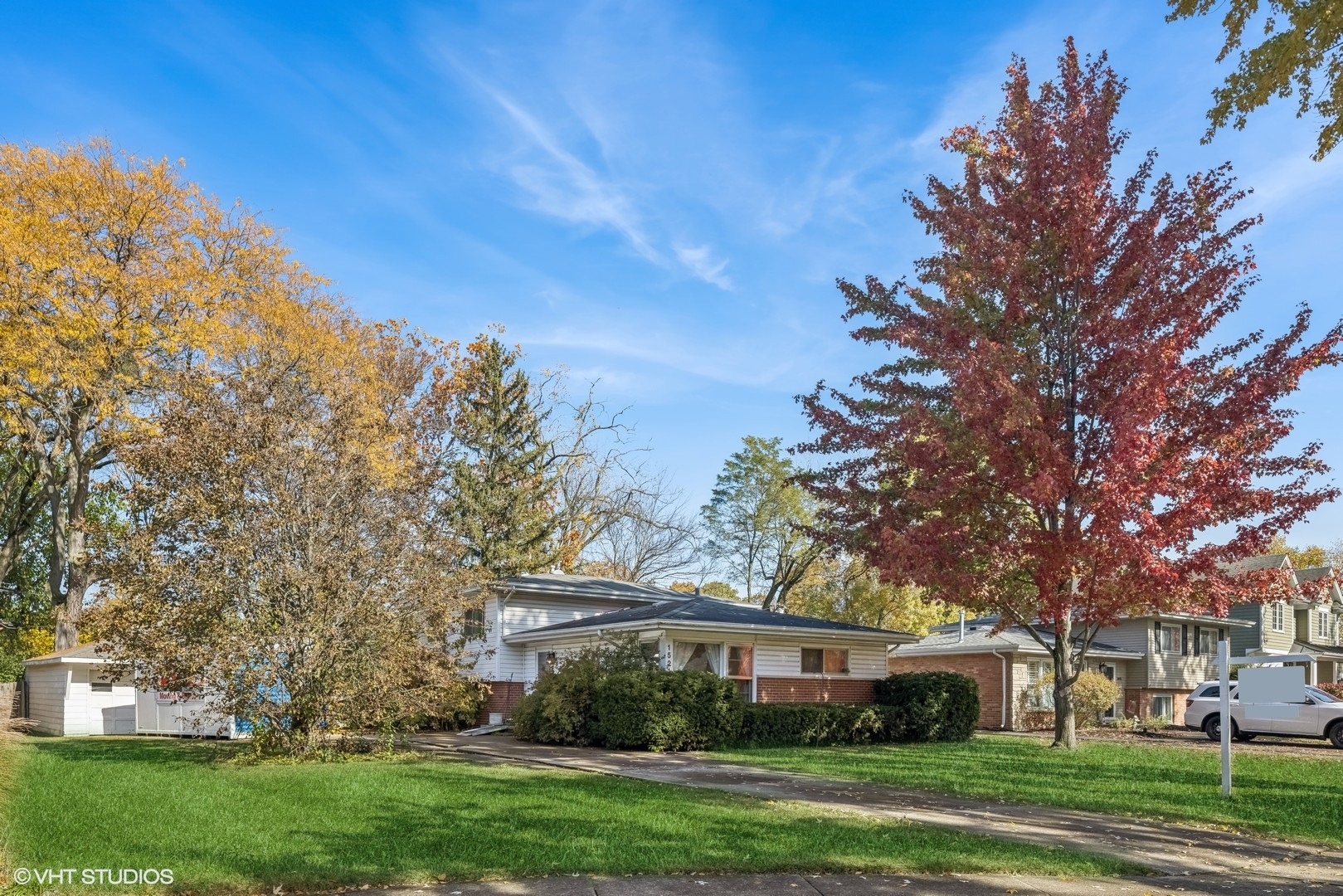 a front view of a building with trees