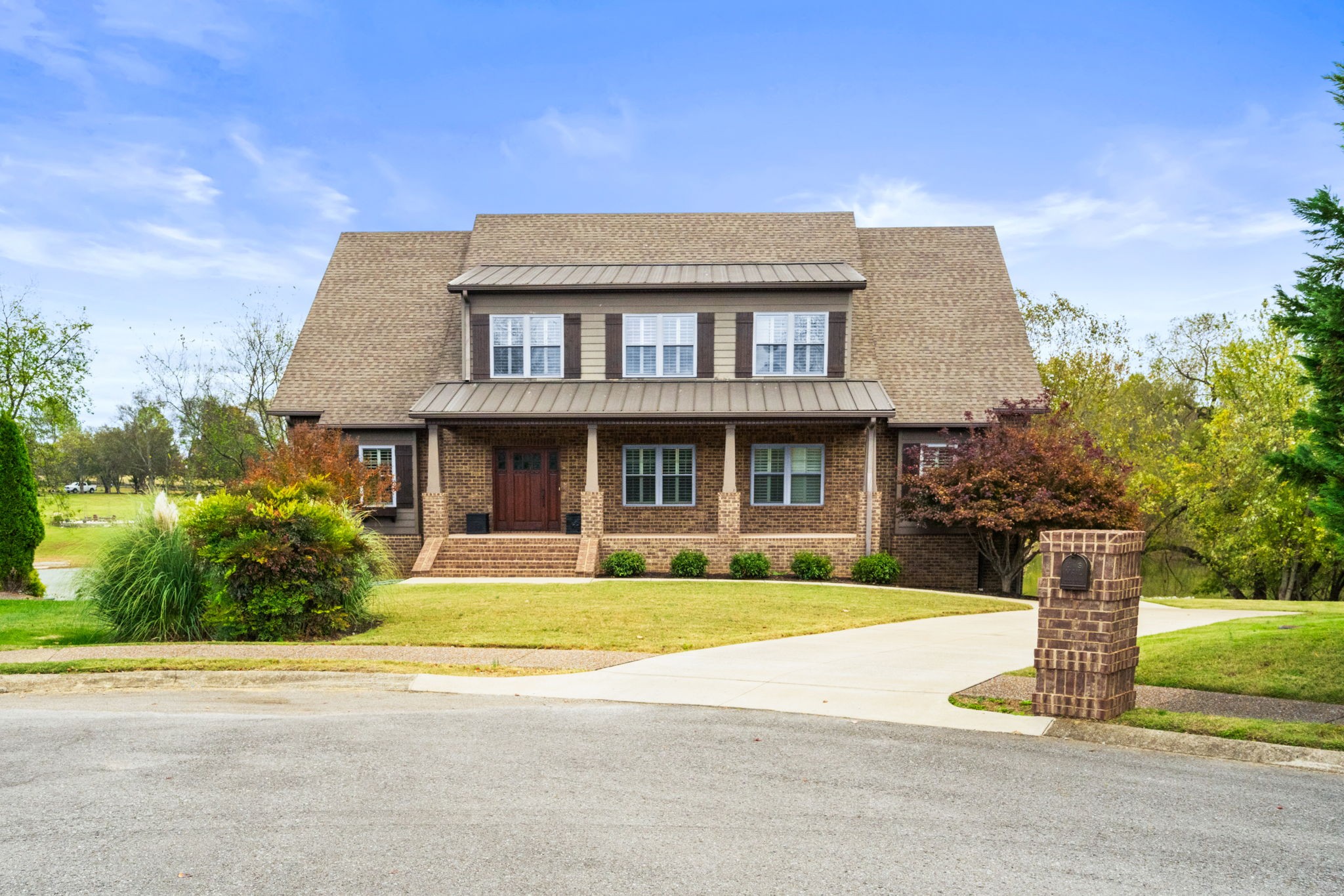 a front view of house with yard and green space