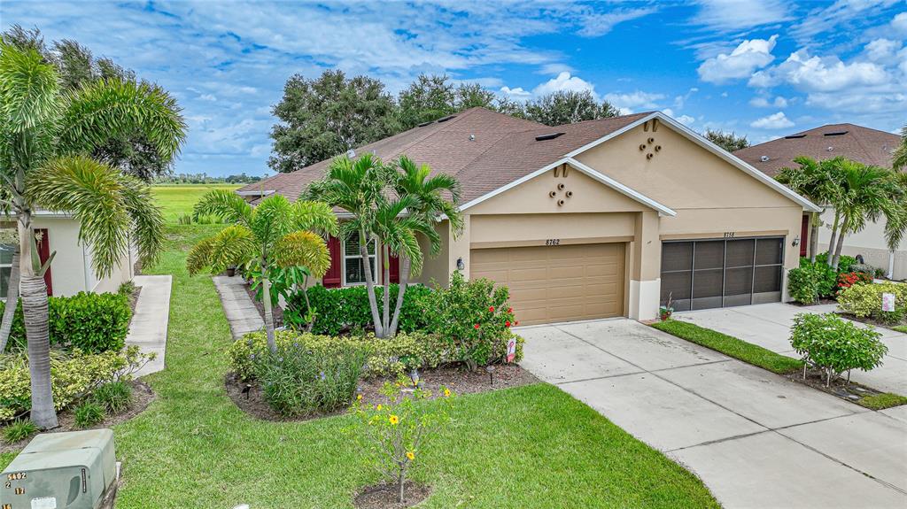 a front view of a house with a yard and garage