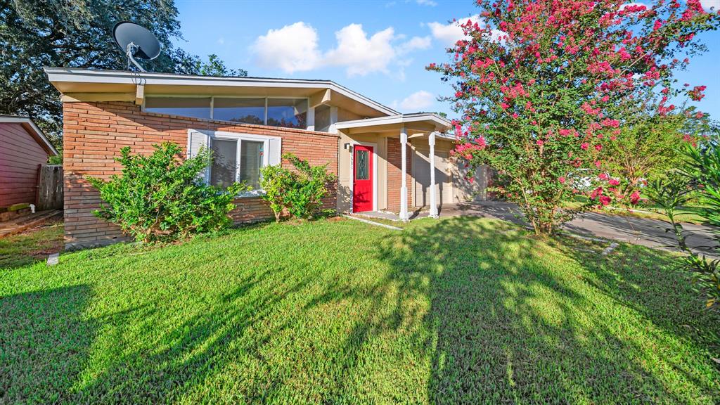 a front view of house with yard and outdoor seating