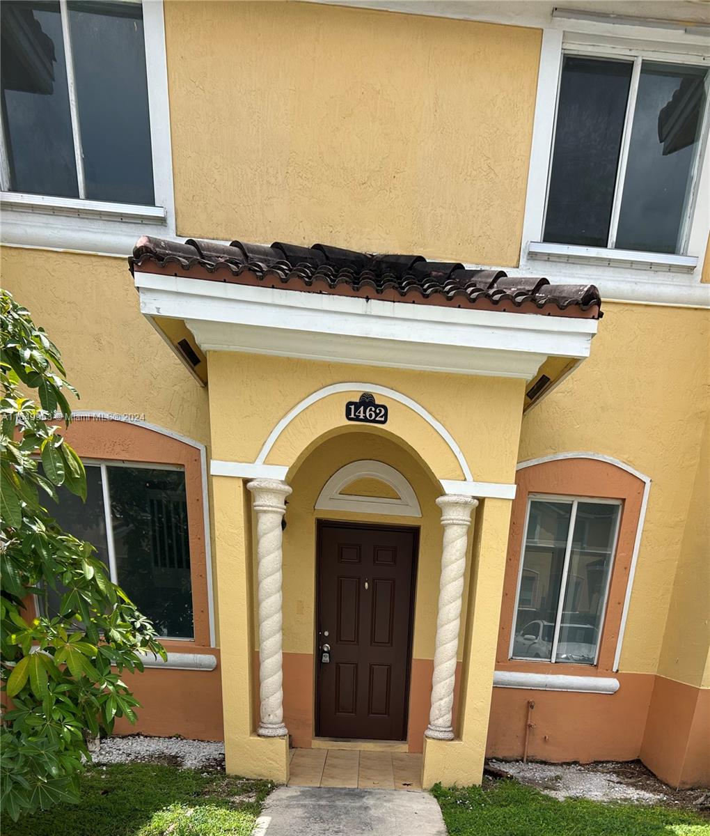 a view of front door and small yard