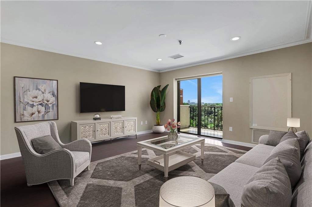 a living room with furniture a flat screen tv and a floor to ceiling window