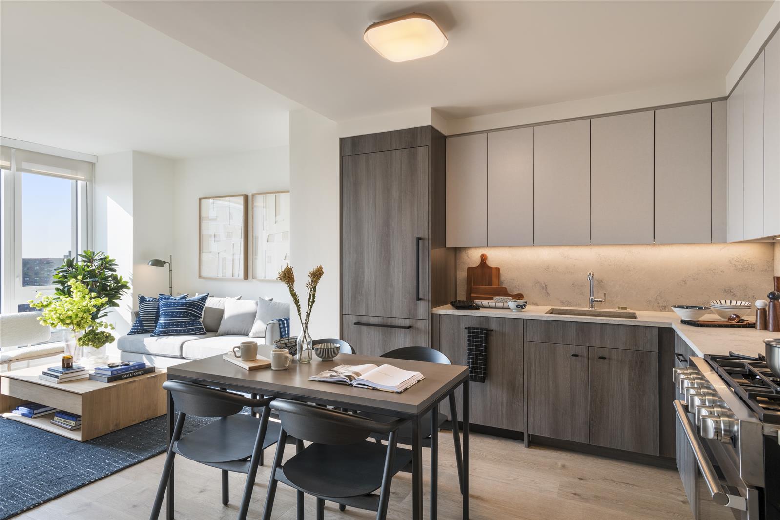 a view of a kitchen area with furniture and wooden floor