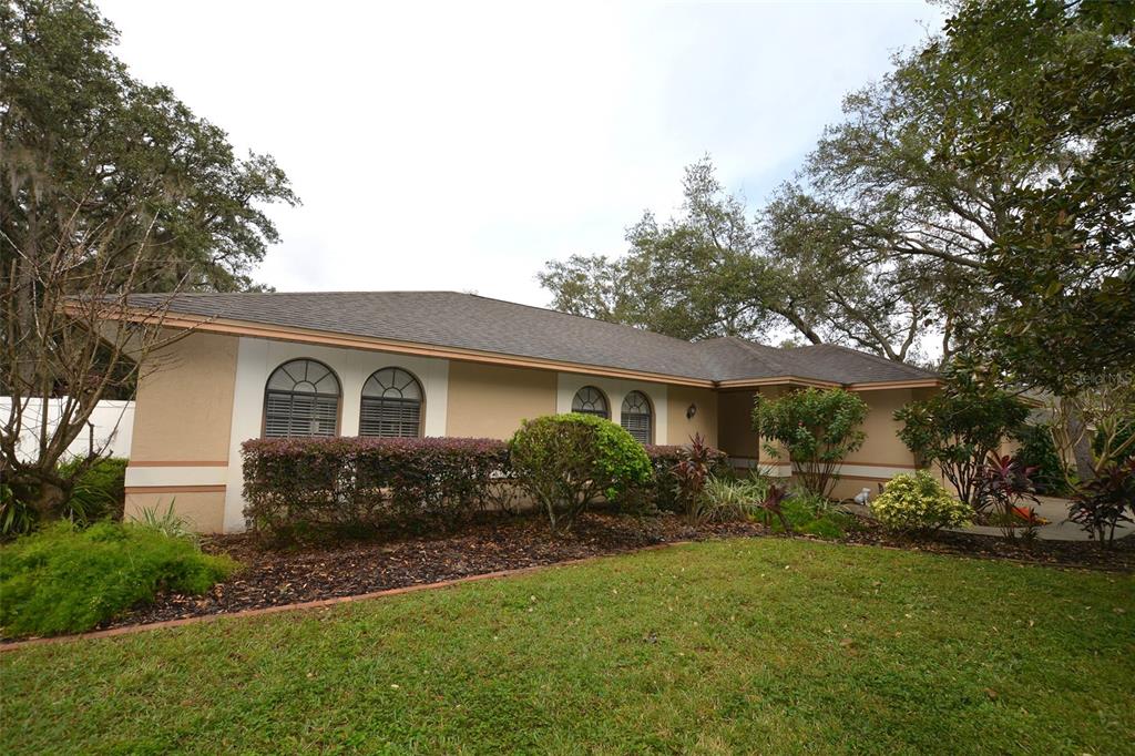 a front view of house with yard and green space