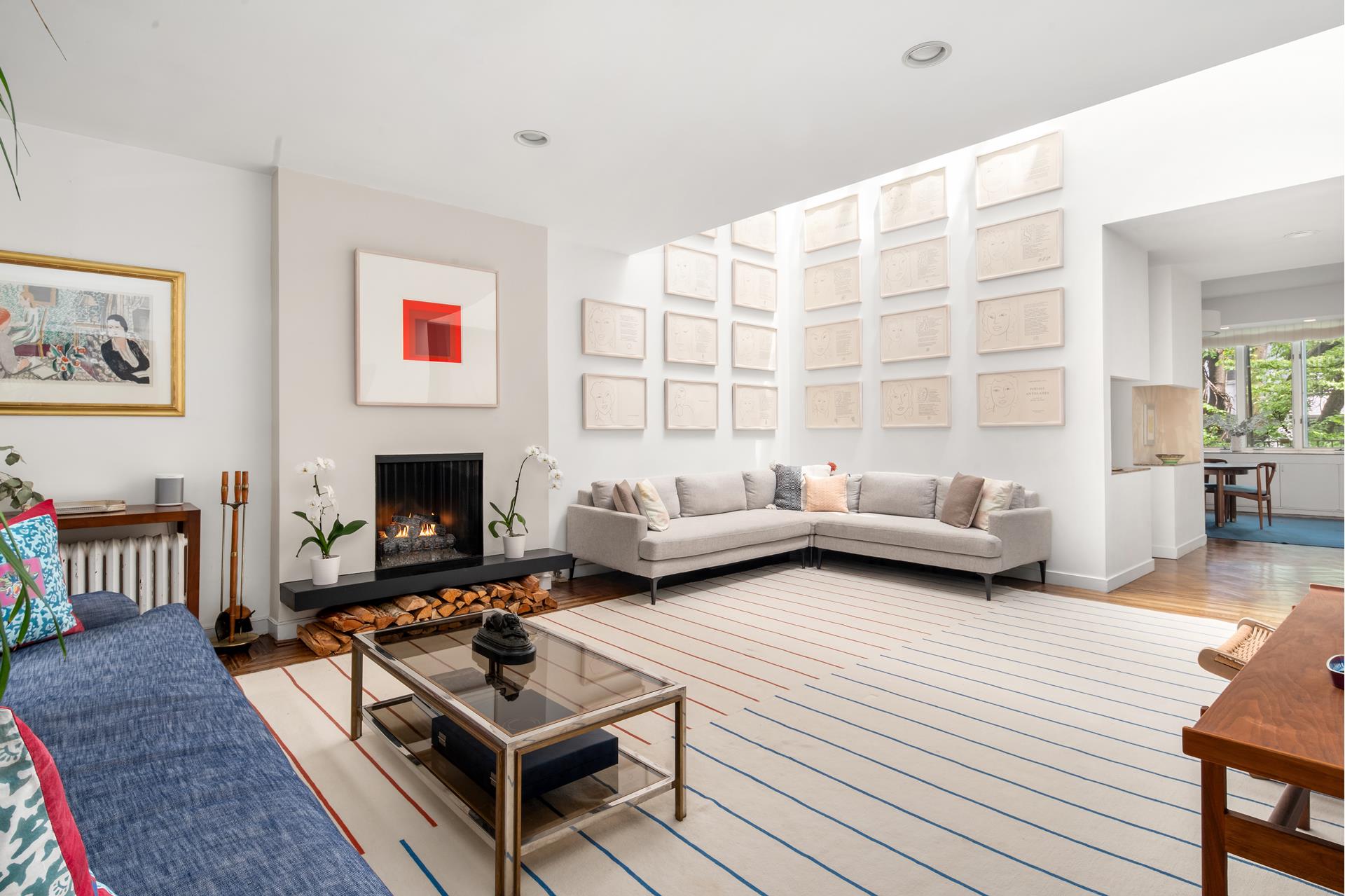 a living room with furniture a rug and a fireplace