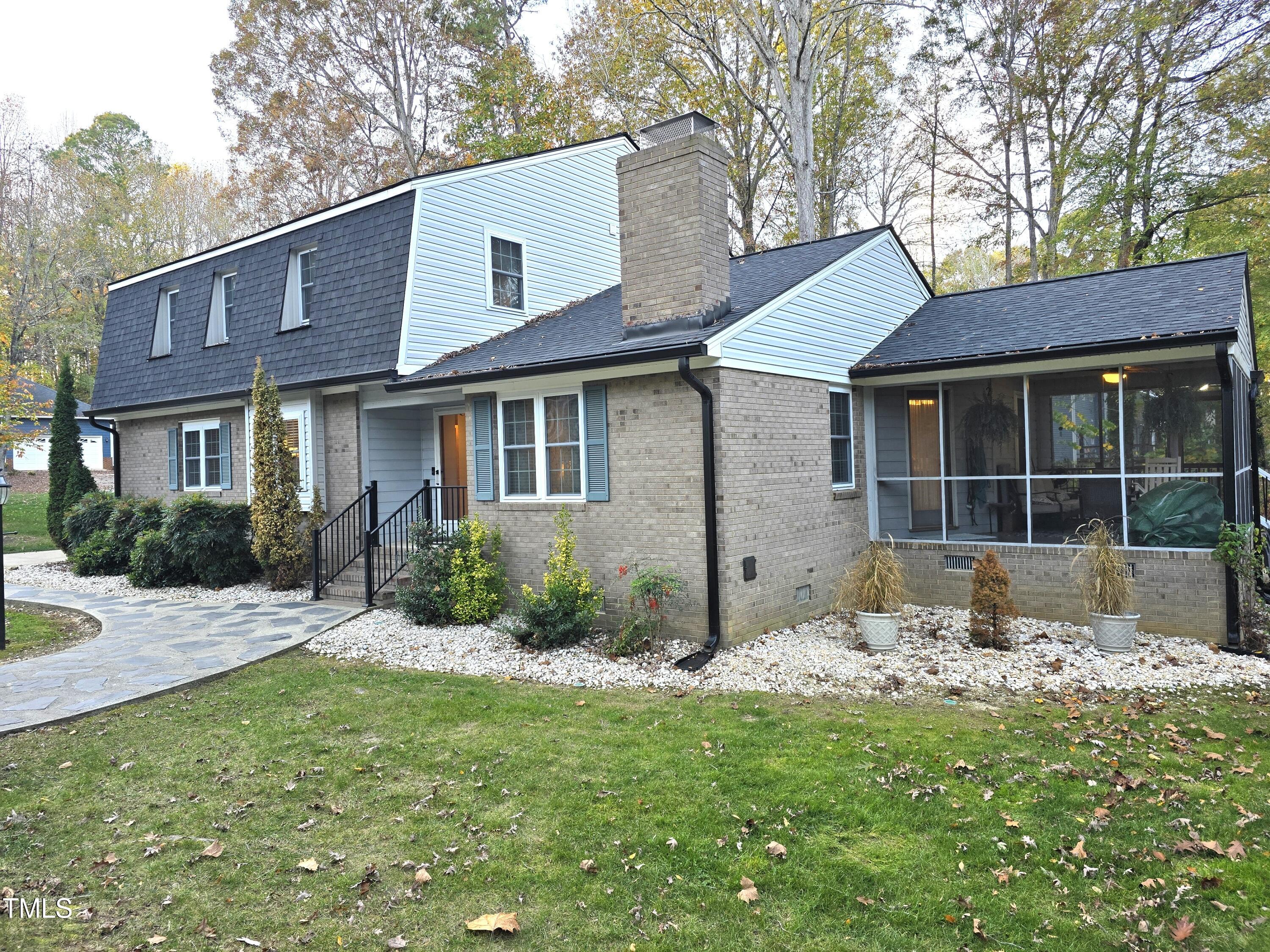 a front view of a house with a garden